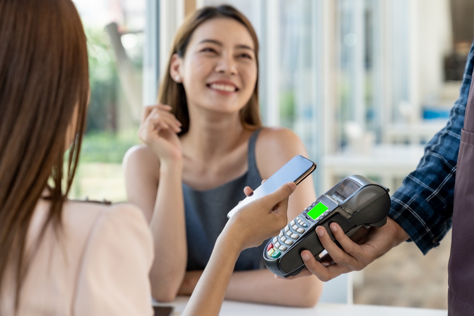 Happy customer paying with her phone